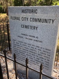 A gravestone in front of a fence  Description automatically generated